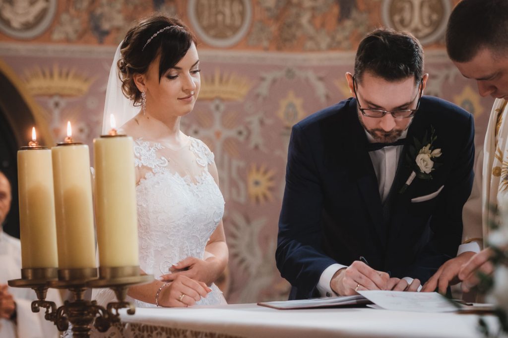 przebieg ślubu kościelnego konkordatowego - podpisanie dokumentów przez parę młodą na ołtarzu